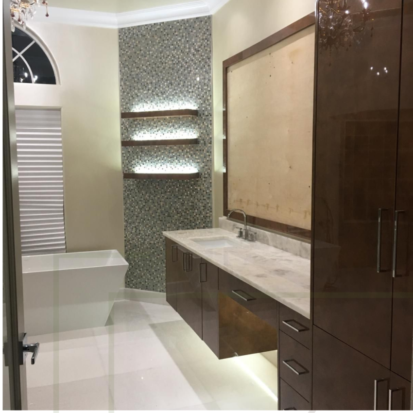 Luxury bathroom vanity with floating wood cabinet, marble countertop, mosaic tile wall, and LED-lit wooden shelves by MR Designer Services in Florida.