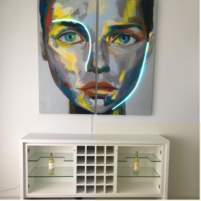 Modern white credenza with a central wine rack and glass shelves, placed below a large portrait painting of a woman featuring an integrated blue neon light tube.